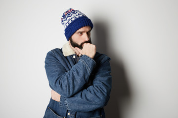 Bearded positive handsome man Wearing blue jeans on white background. Studio shot
