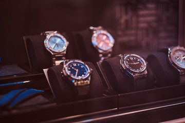 Close-up photo of a showcase with exclusive men's watches in the luxury jewelry store
