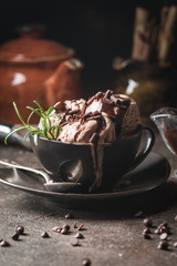 Chocolate coffee ice cream balls in a bowl over dark background