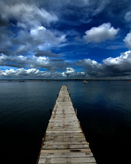 Old Wooden Dock out in Water with Sky Clouds Lake