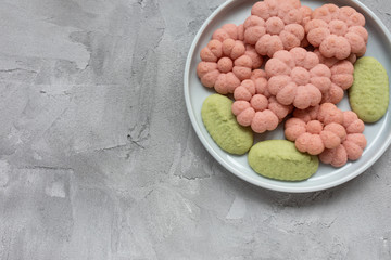Flower cookies on a plate on a gray background . Spring holidays cooking concept.