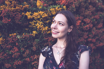 Beautiful brunette in a garden, smiling