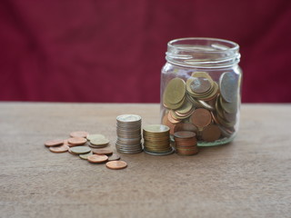 coins in jar on black background