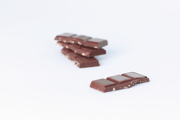 stack pieces of chocolate with nuts isolated on white