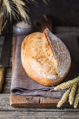 Freshly baked homemade traditional bread on rustic wooden table