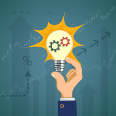 Light bulb with gears in the hand of a businessman.