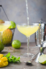 Margarita Mango alcoholic cocktail in a glass on stone background.