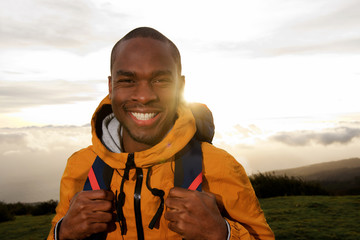 Close up happy african american male hiker during sunset