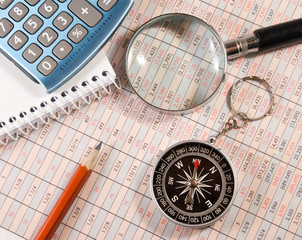 pencil, magnifier,compass and calculator on the table close-up