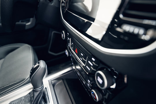 Car interior. Modern car illuminated dashboard. Luxurious car instrument cluster. Close up shot of automobile instrument panel. Modern car interior dashboard and steering wheel © svetlichniy_igor