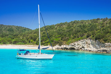 Beautiful bay with sailing boat, Greece. Vacations, travel and active lifestyle concept. Greek...