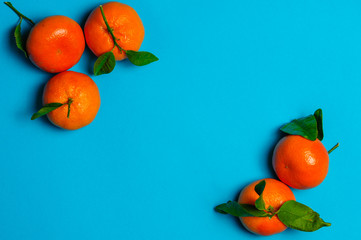 Orange clementimes on blue table