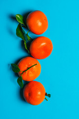 Orange clementimes on blue table