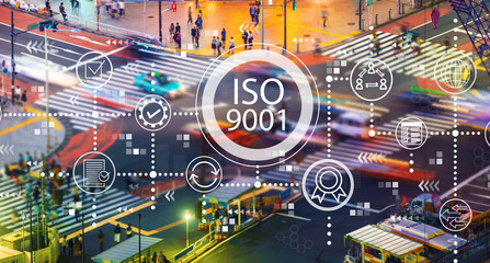 ISO 9001 with busy city traffic intersection at night
