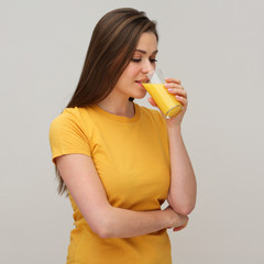 Young woman drinking orange juice.