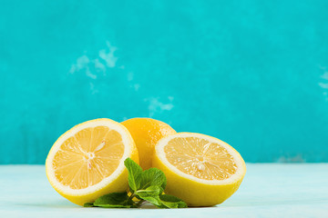 Fresh lemons. Mint and lemon halves on blue fresh background