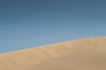 Fototapeta na wymiar Desert landscape with Blue Sky and Wave pattern in sand, Spain