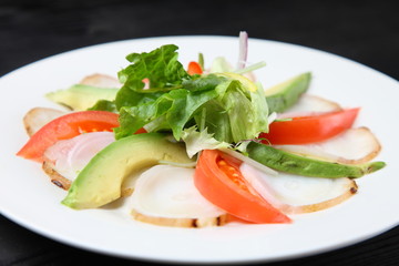 Octopus carpaccio with avocado and tomato