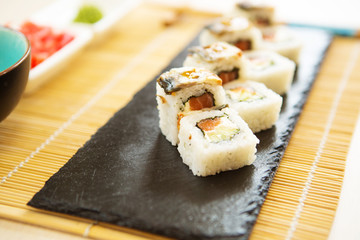 Sushi Set nigiri and sushi rolls on gray stone slate on stone background. Sushi menu. Japanese food.