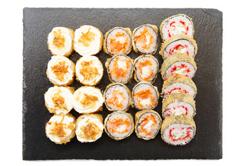 Delicious sushi rolls, nigiri and salmon sushi rolls. Sushi isolated on shale food board on white background