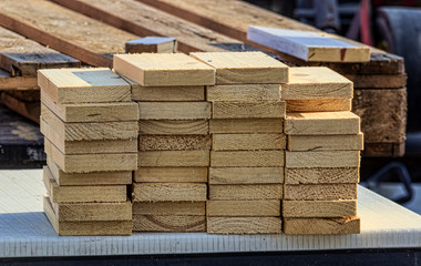 wooden planks neatly piled outdoors. Concept of woodworking works