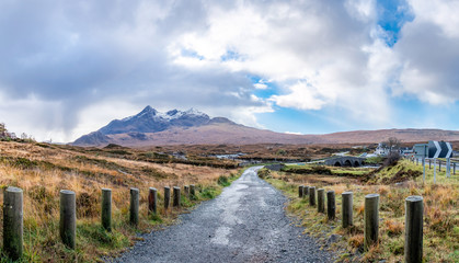 Old massive stone bridge crossing shallow river in Sligachan, Isle of Skye, Scotland