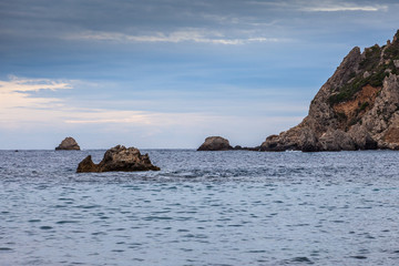 Paleokastritsa bay cliffs and rocks on a cloudy day