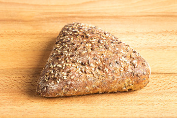 Integral bread in the form of a triangle with linseed, oats and sesame seeds