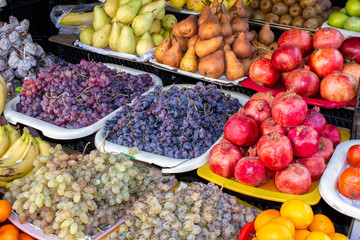 Georgia, the local bazaar. Selling fresh fruits and fruits - pomegranates, apples, pears and grapes.
