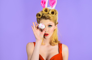 Happy Easter! Easter day. Spring holiday. Woman with rabbit ears holds white eggs. Egg hunt. Easter bunny. Easter concept. Woman witn bunny ears. White eggs. Bunny girl. Kiss.