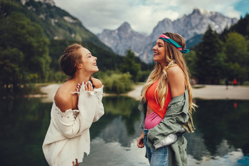 Two young women tourist  have fun on the lake
