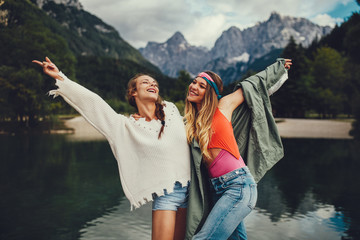 Two young women tourist  have fun on the lake