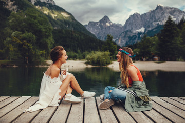 Two young women tourist  have fun on the lake