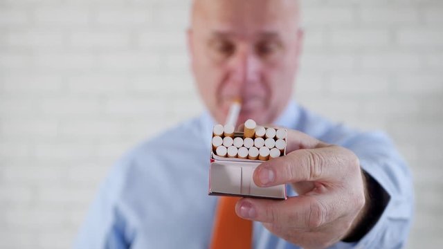  Friendly Businessman at Office in a Working Pause Smoke and Offer a Cigarette