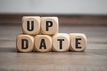 Cubes dice with update on wooden background