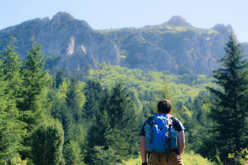 Naklejka premium Hiker under the mountains 