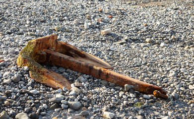 Old ships anchor on a stoney beach