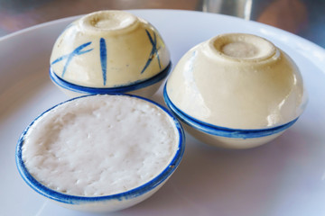 Traditional thai desert of coconut milk custard in small porcelain cup