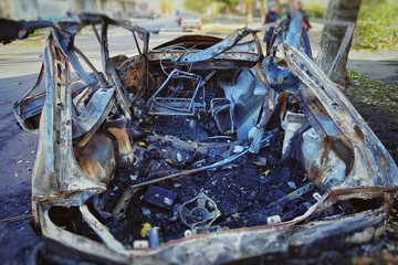 The blown-up car as a result of terrorist attack.