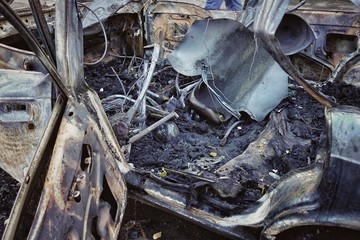 The blown-up car as a result of terrorist attack.