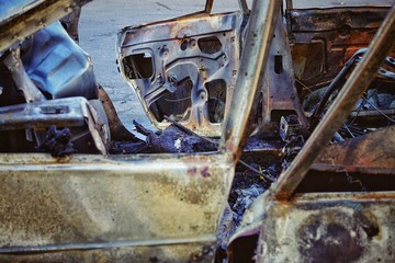 The blown-up car as a result of terrorist attack.