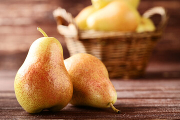 Ripe pears on brown wooden table