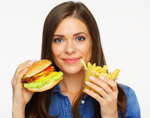 Woman eating fast food, burger with french fries.