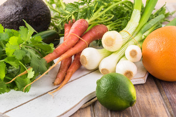 Ingredients for roasted pork chops and vegetables with  orange avocado salsa