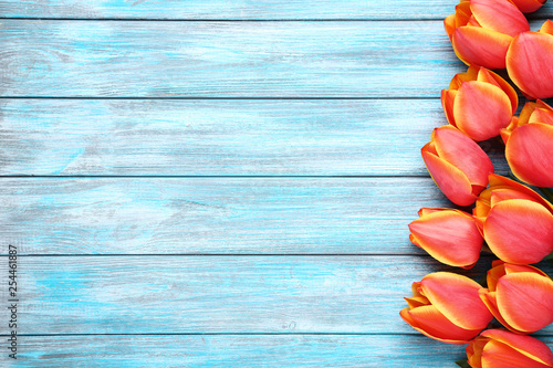 Bouquet of tulips on blue wooden table