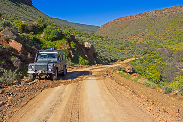 Mountain track with Off roader in foreground © geoffsp