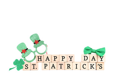 Clover leaf with glasses, bow tie and inscription Happy St. Patrick's Day on white background