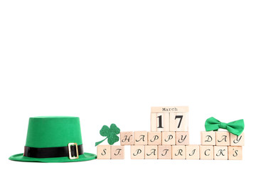 Green hat with wooden calendar, clover leaf and inscription Happy St. Patrick's Day