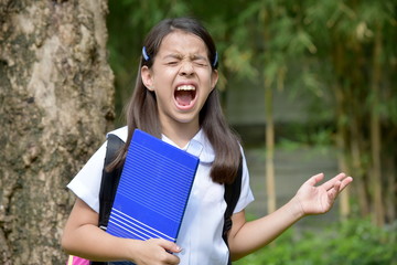 Fototapeta premium Anxious Female Student School Girl Wearing Uniform With Books