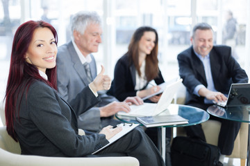 Successful happy business people using laptop and talking about a work. Shallow depth of field. Please see more photos and video ( Business concepts ). 